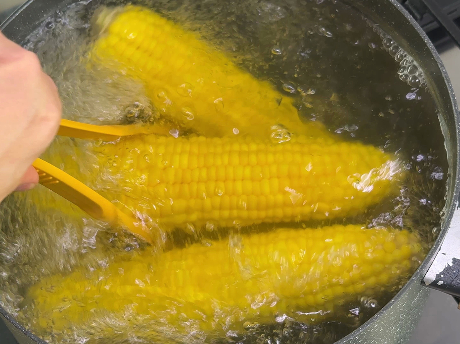 Corn being boiled in a pot
