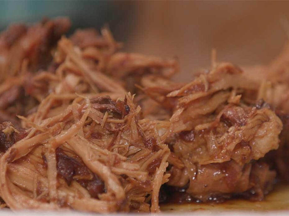Cooked, shredded pork roast in cranberry sauce.
