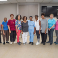 A group of twelve women standing in a row.