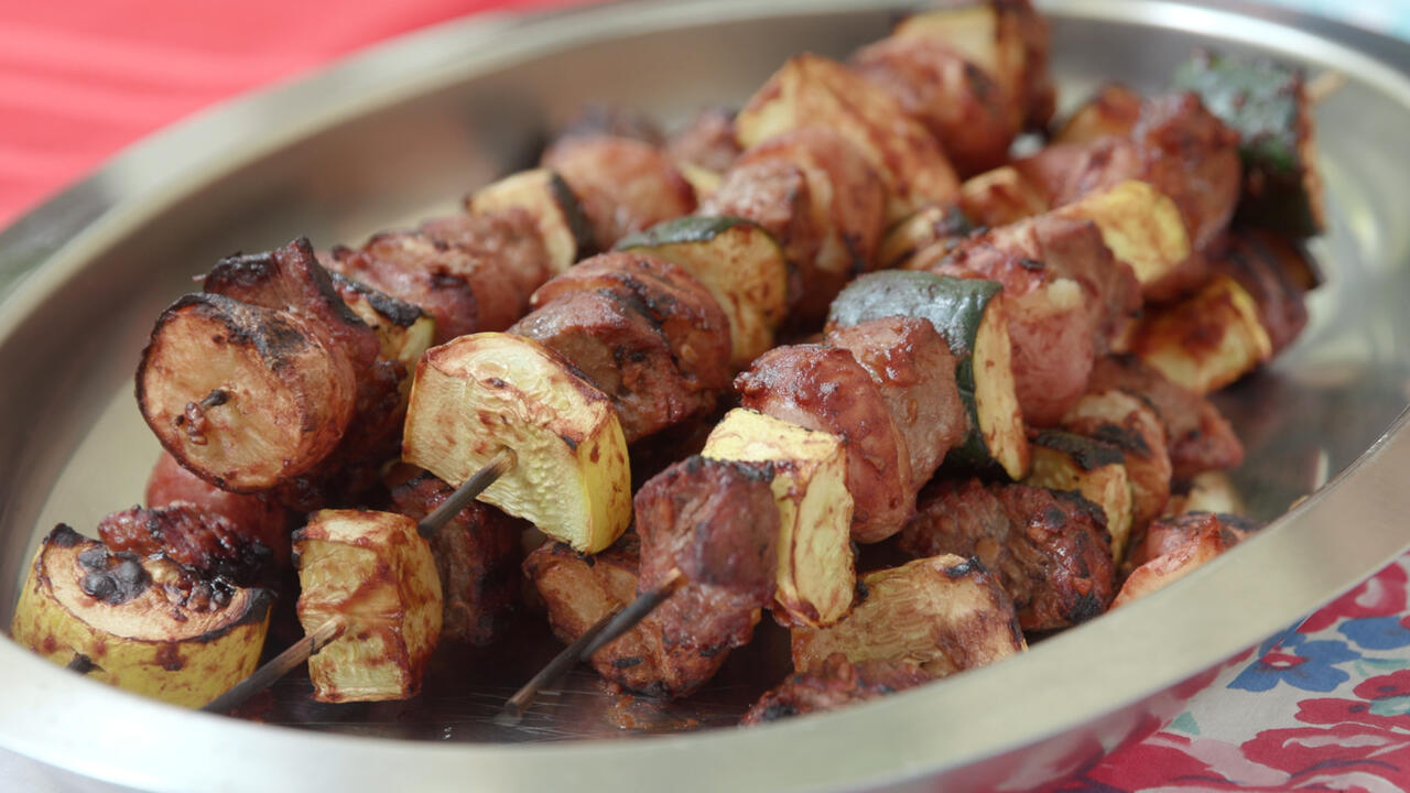 Beef and potato kabobs on a stainless steel platter