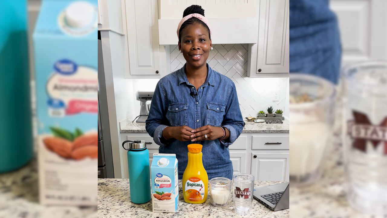 A woman in a kitchen with food products on the counter