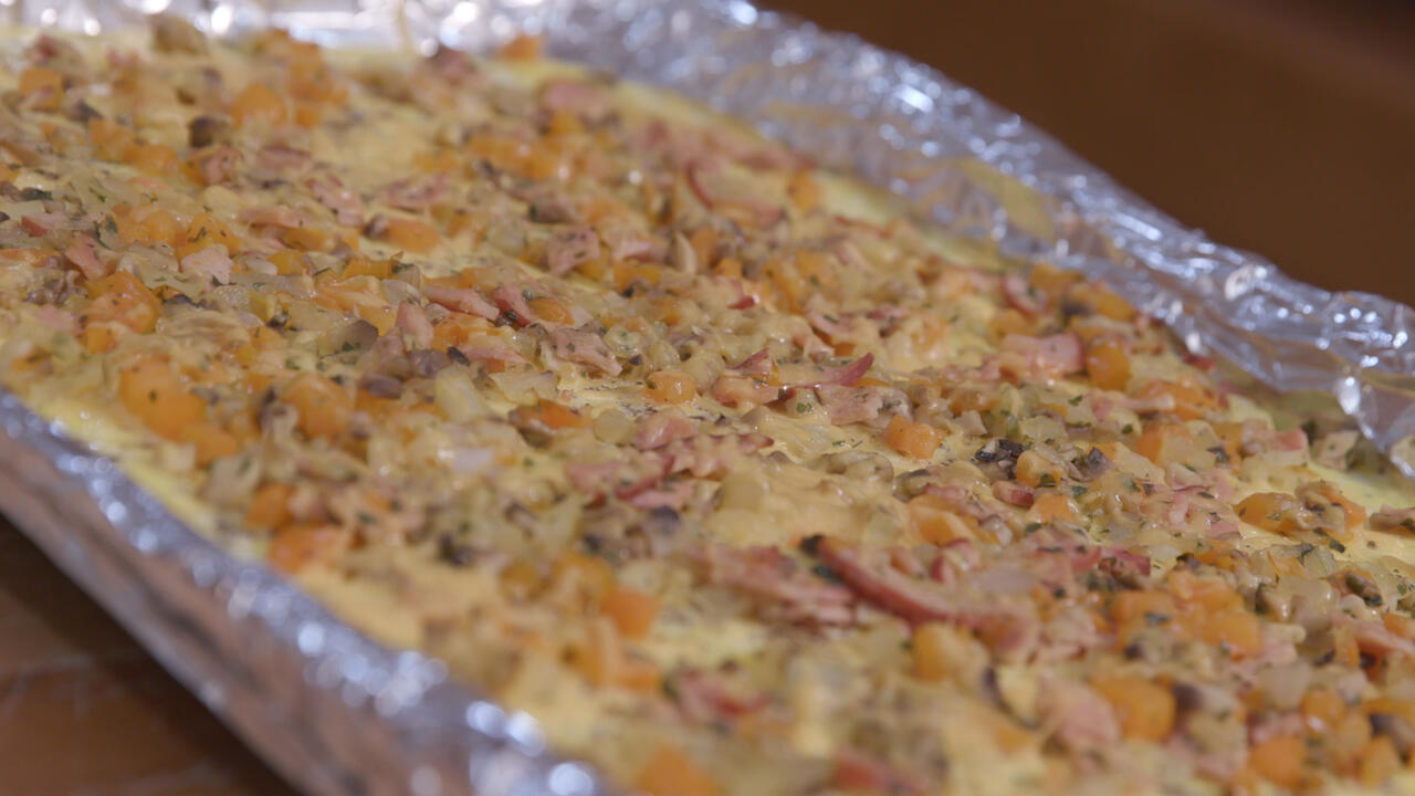 Omelet ingredients cooked on a foil-covered sheet pan