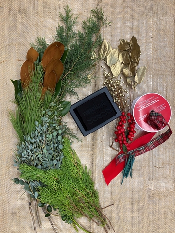 Evergreen cuttings, ribbon, and supplies to make an arrangement.