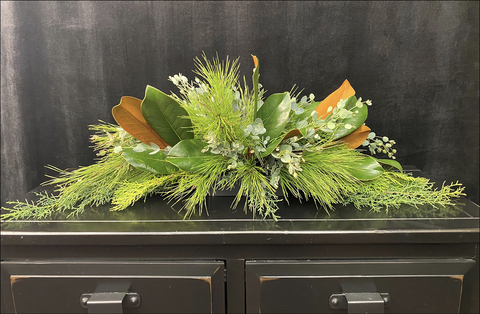 Various evergreen pieces forming an arrangement.
