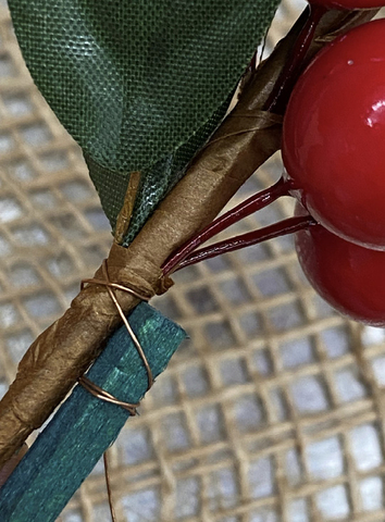 A wooden pick wired to a berry spray stem.