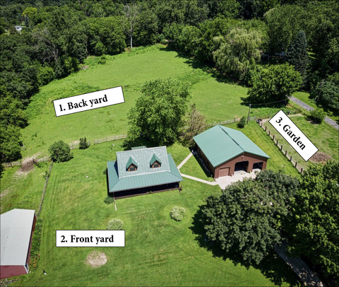 Aerial view of the property showing a house, front yard, backyard, and garden area.